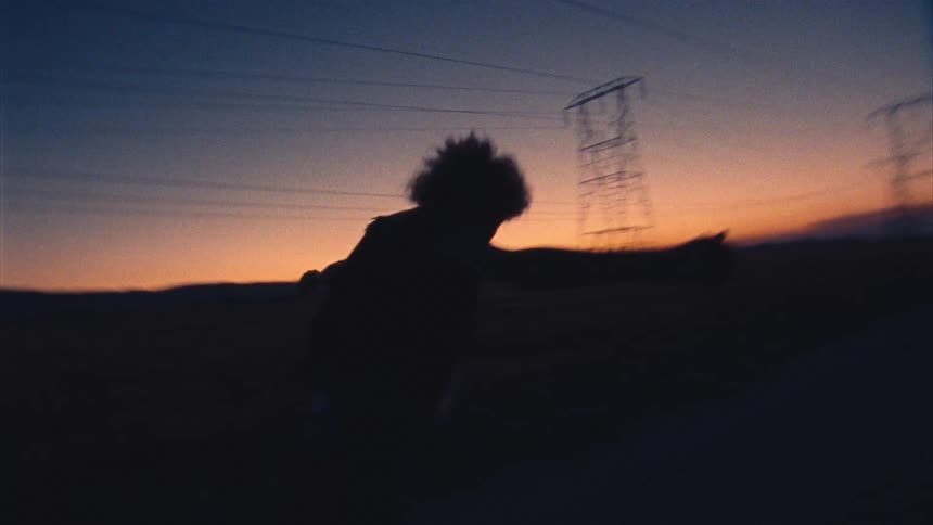A woman is running by the power lines