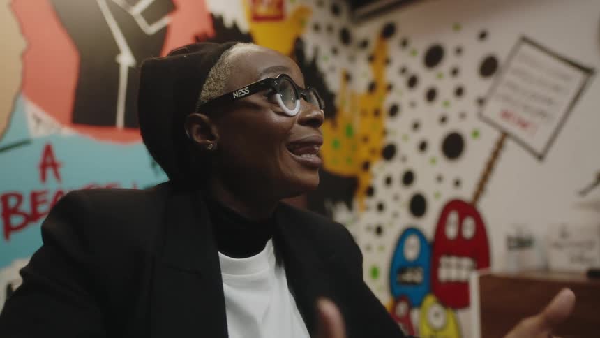 A woman speaks animatedly during an office meeting