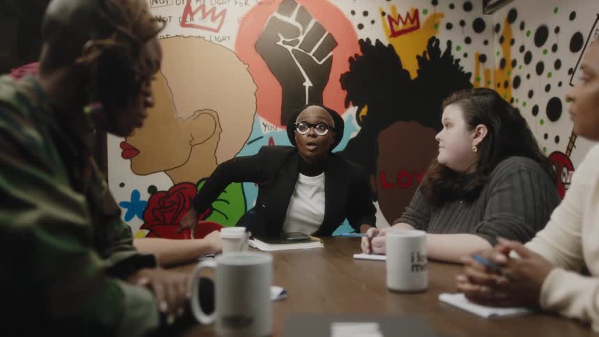 People talk at a meeting