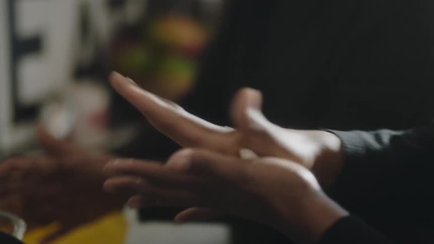 A view of two people making food together