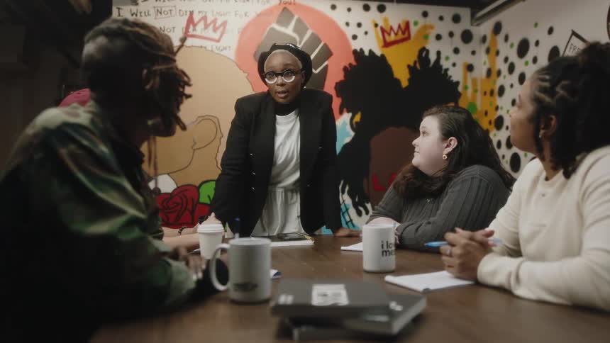 A woman talks to coworkers