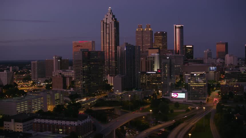 Aerial view of city skyline with skyscrapers at dusk