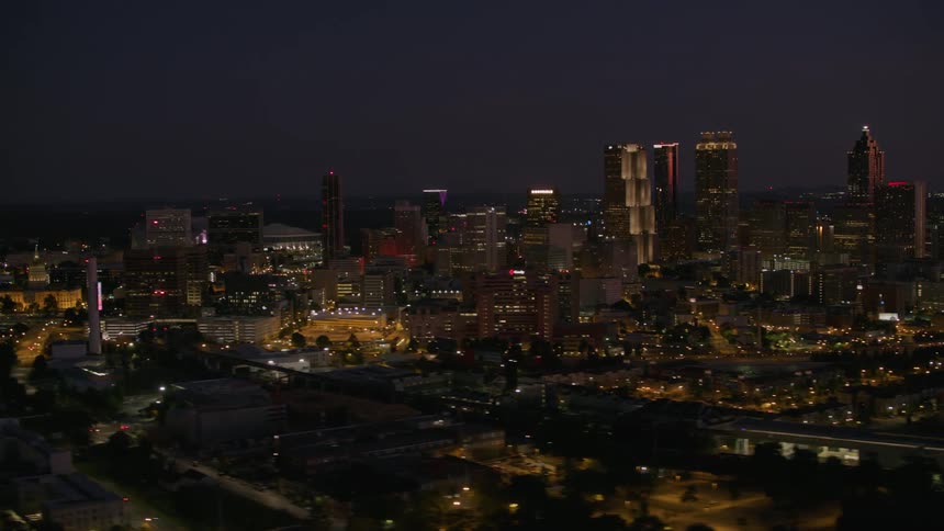 Aerial view of illuminated skyscrapers and buildings in the city at night