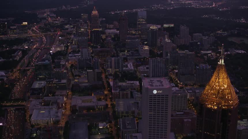 Aerial view of cars driving through a downtown city at night