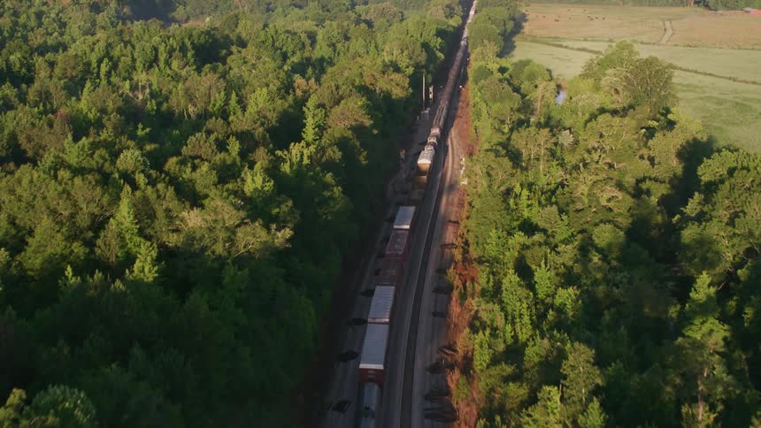 Aerial view of a train driving in a rural area