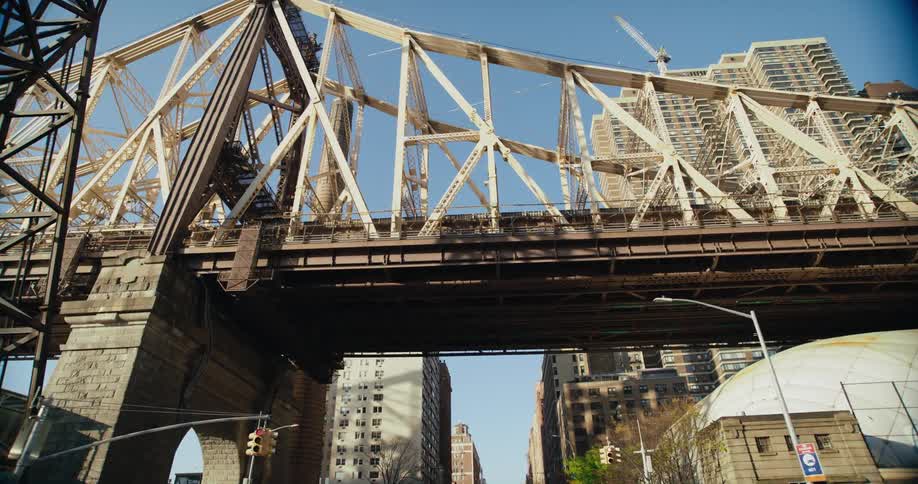 A rusted bridge runs through downtown