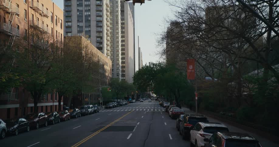 Vehicles are parallel parked along a city street