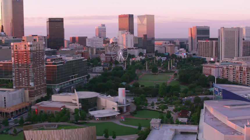 A stadium and an amusement park with a ferris wheel sit in the heart of downtown