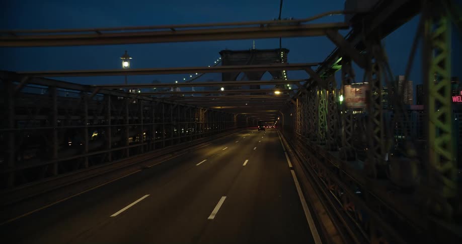 A view of a bridge at night in a city