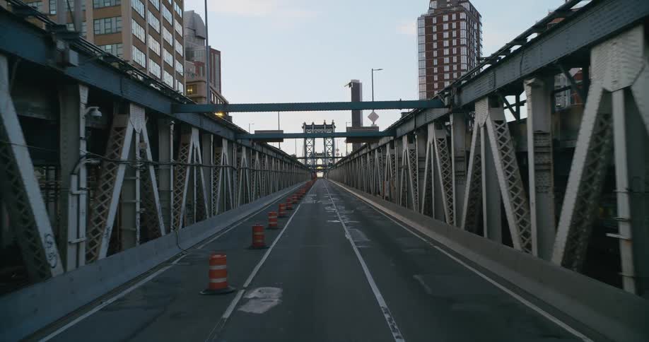 Construction cones line the center of a bridge near downtown