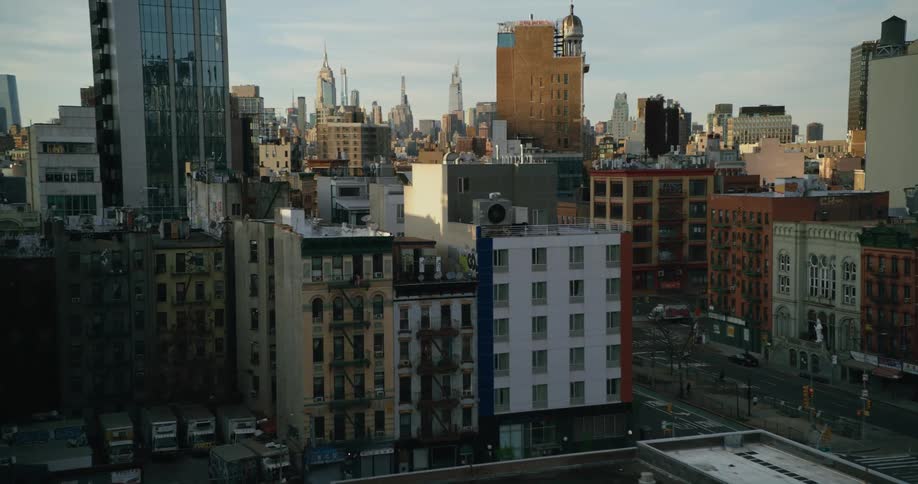 Apartment buildings sit close together in a neighborhood with views of downtown