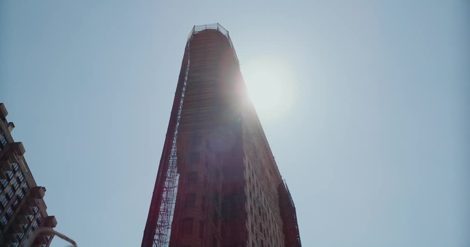 Slow motion footage of the sun shining over the flatiron building in new york city