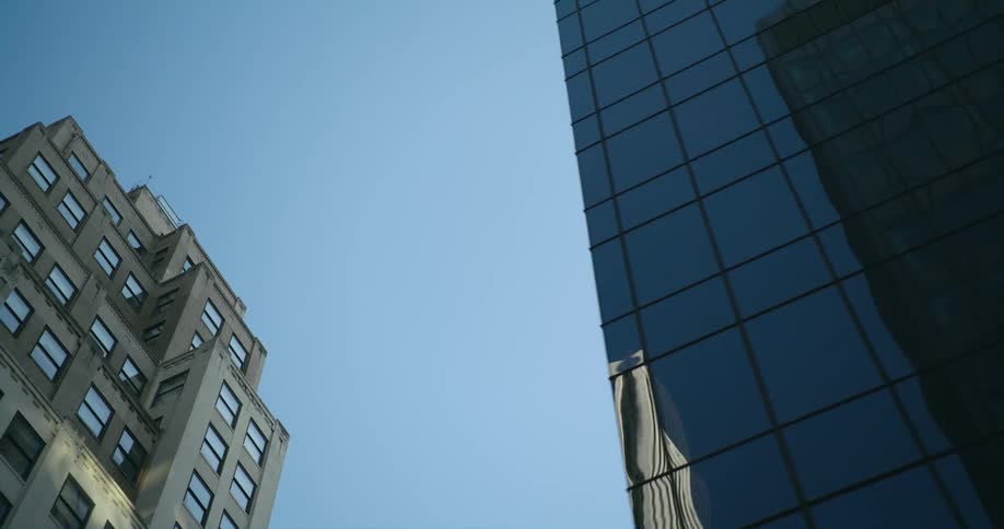 Reflections of buildings on windows in a city