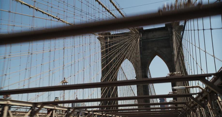 Vehicle crosses the bridge with tower and american flag