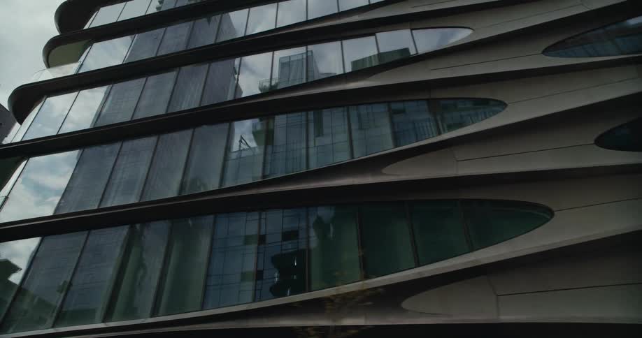 Skyscrapers reflect off the mirrored surface of an apartment building
