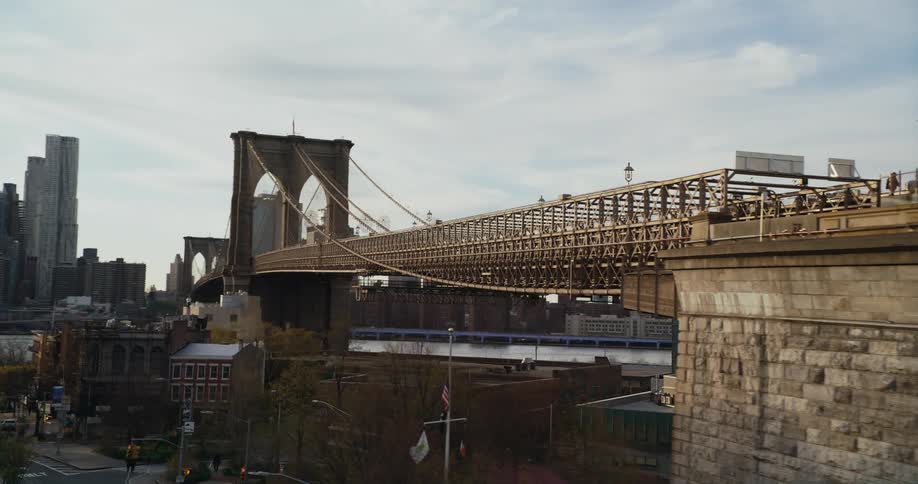 A long bridge crosses a river and connects a highway to downtown
