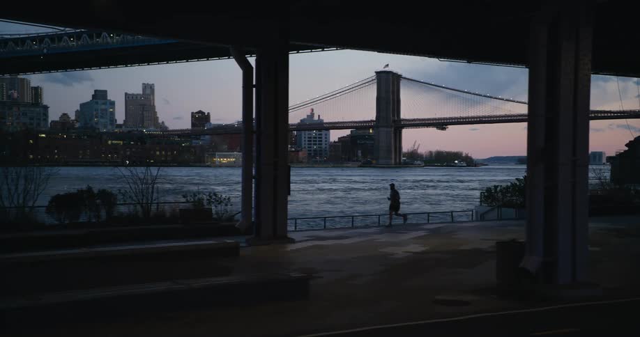 People are running by the water near the city