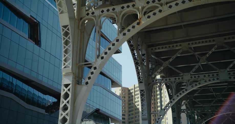 Apartment and other buildings border bridge overpass