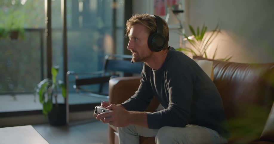 A man is playing video games at home