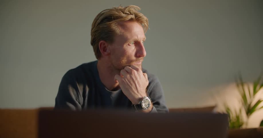 A man works on his laptop at home