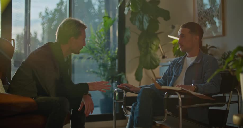 A man gets mad at his therapist and slaps his book out of his hands