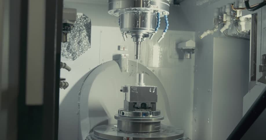 Automatic silver lathe tool machining a small piece of metal