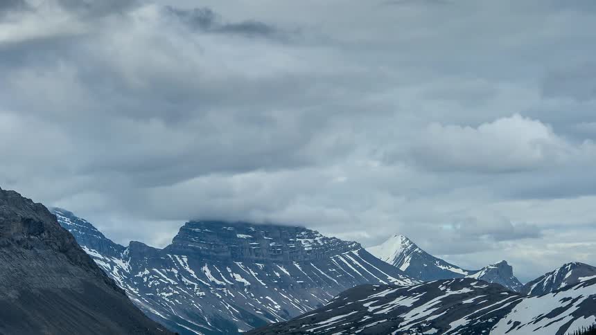 Clouds moving over a mountain