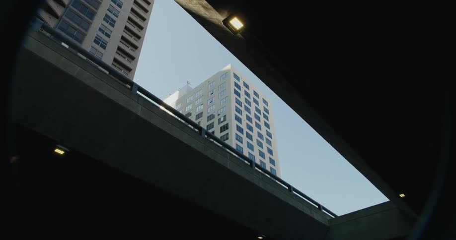Apartment buildings seen through the opening of a highway in the city at morning