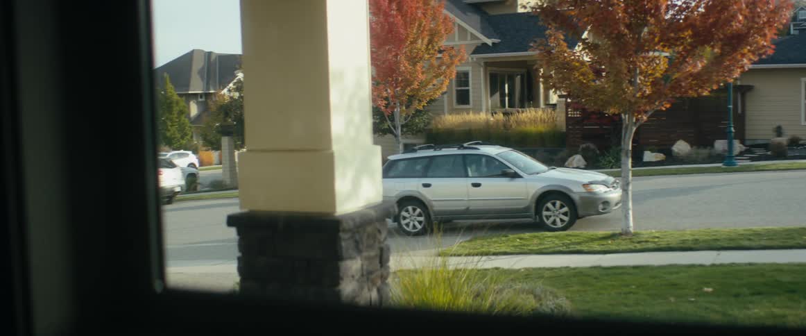 Car parking on the street in front of a house in a neighborhood at morning