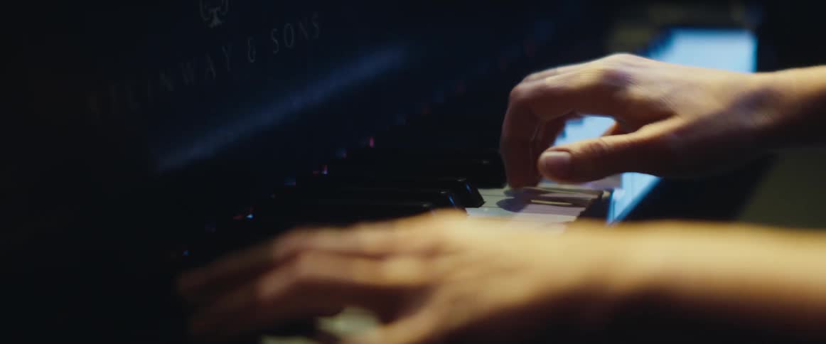 A person skillfully uses both hands while playing the piano