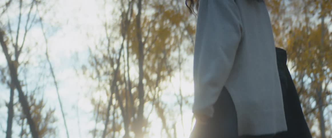 A girl holding the hands of her parents swings in the air between them
