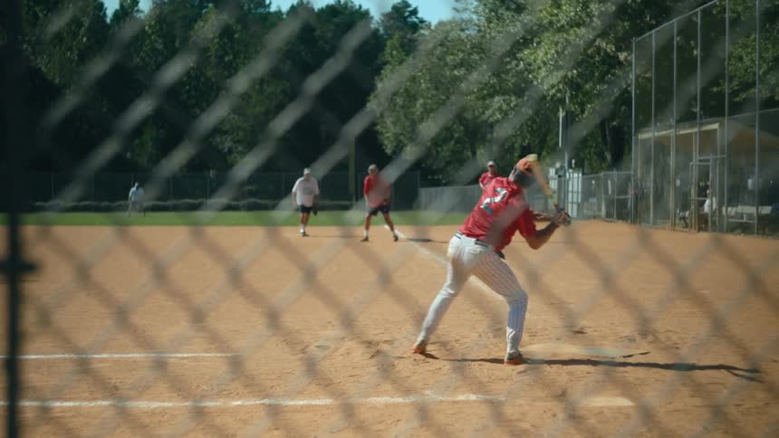 A baseball player runs to first base after hitting a ball