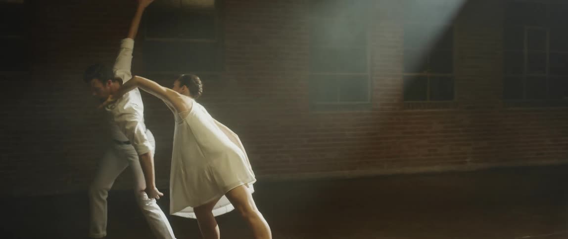 A man and woman are dancing in the ballroom