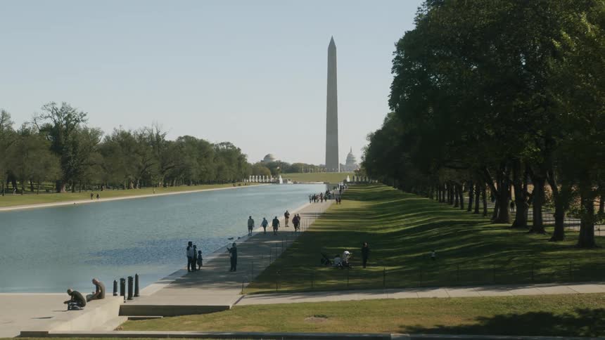 People are walking outdoors at a public park in spring