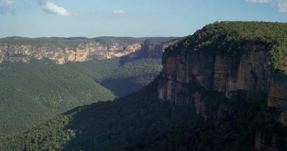 The mountain range is covered in green