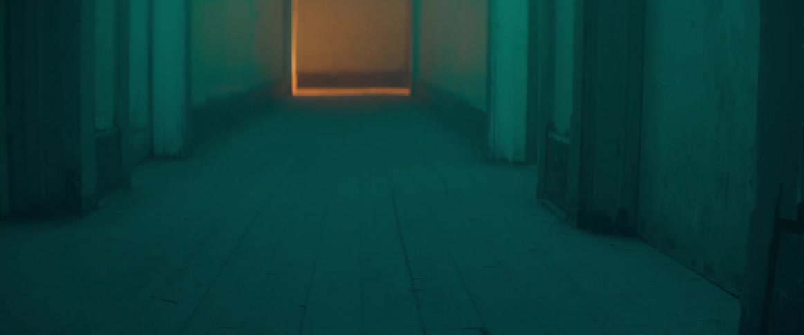 A person is walking down a hallway in a building