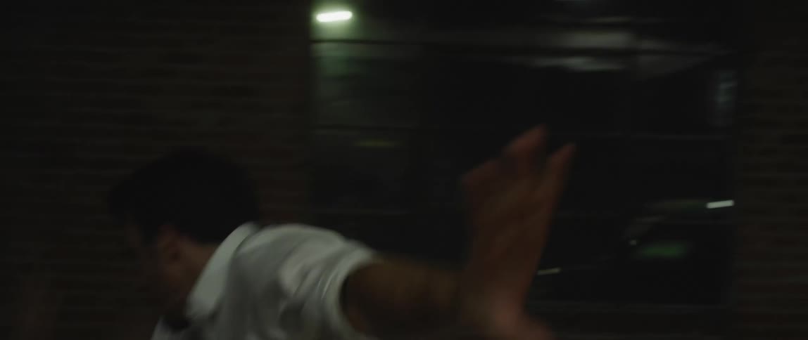 Male with dancer with white shirt dances in spotlight in room
