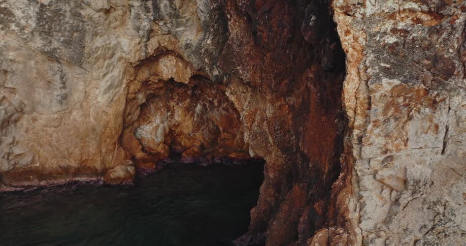 A river runs through a cave in a canyon