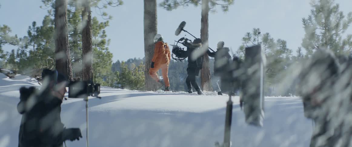 A film crew are filming as it snows