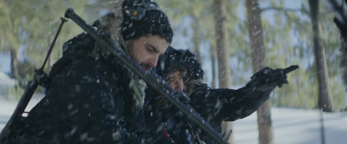 A film crew is working as it snows