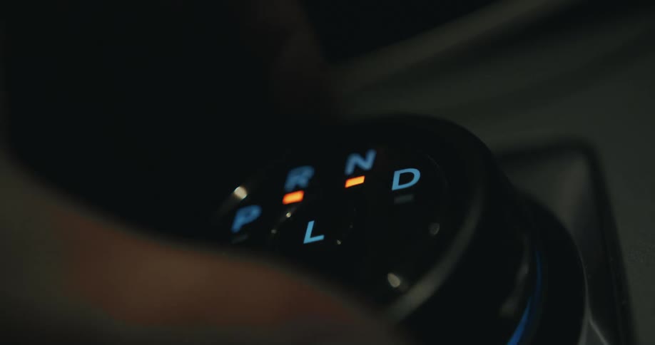 A person turns the knob changing the gears