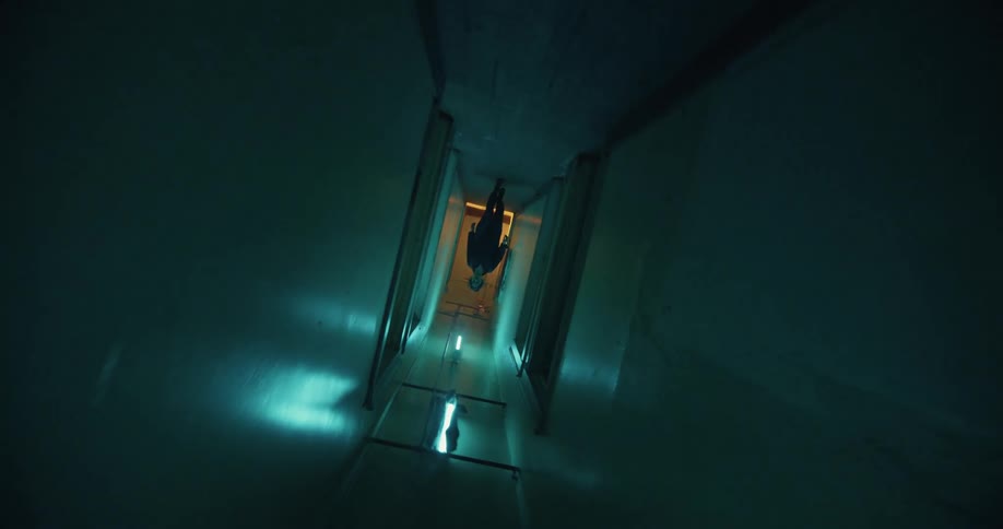 A person is walking down a hallway in a building