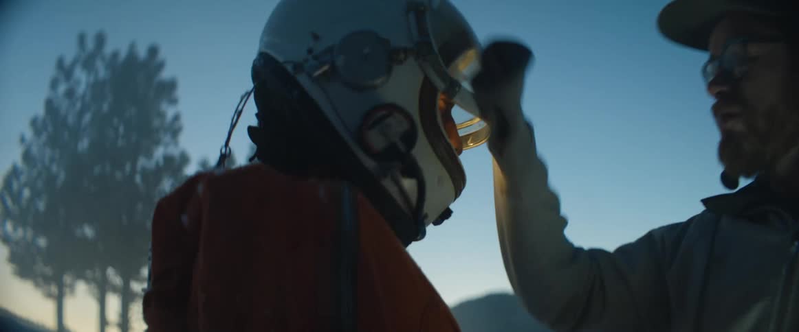 A man wipes off the persons helmet