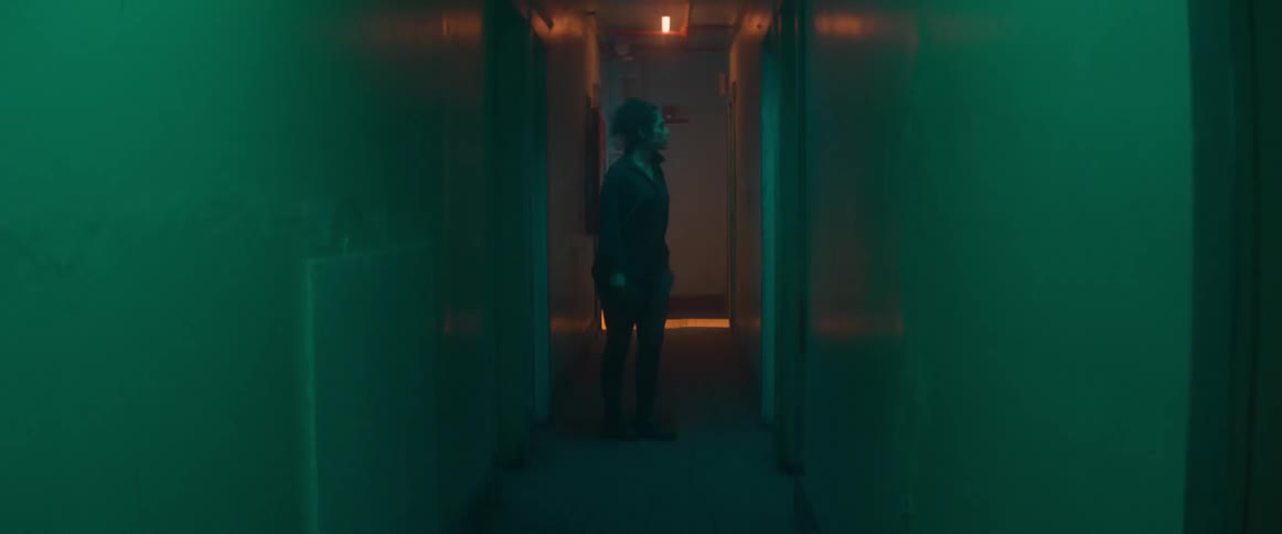 A woman walking around in a hallway