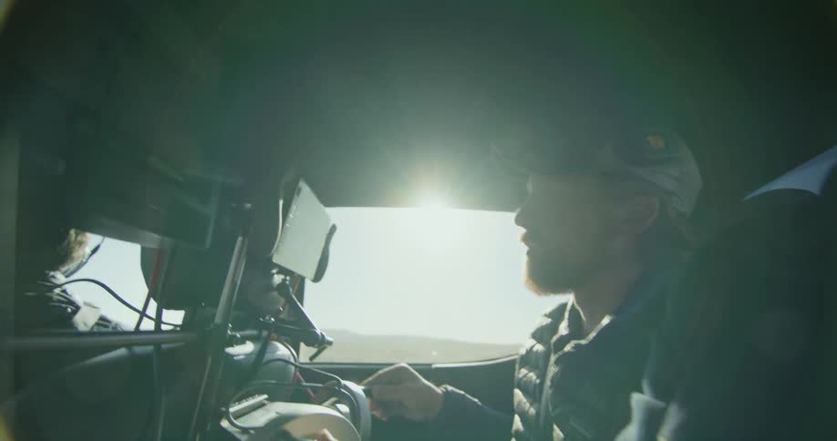 A man is a passenger in a car driving through a rural area
