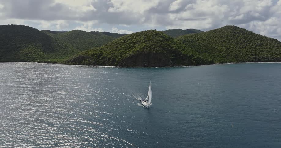 A boat is driving through the ocean during midday