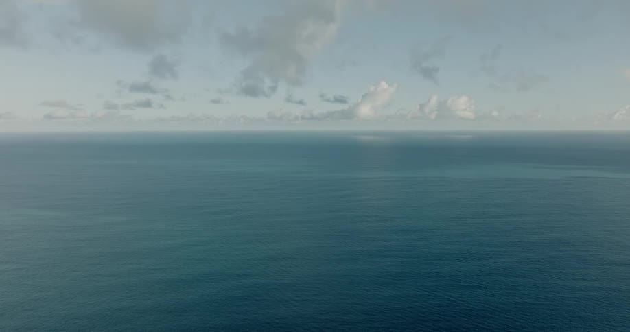 Clear blue water waves and ripples under a cloudy sky