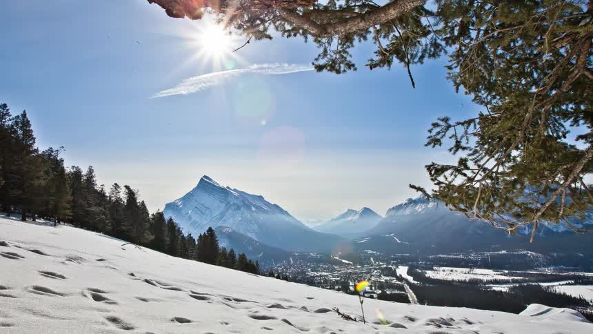 A mountain range is in the distance on a sunny day