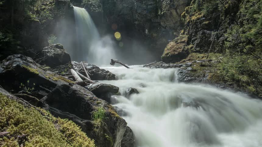 Water flowing down a mossy, rocky area