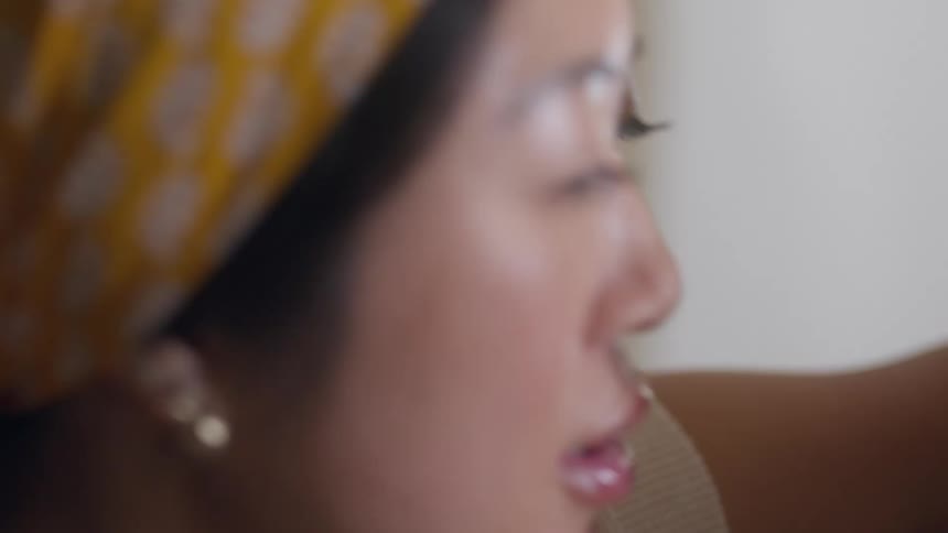 A woman grabs her partners face and leans in to talk to him